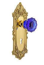 Load image into Gallery viewer, Nostalgic Warehouse 725967 Victorian Plate with Keyhole Privacy Crystal Cobalt Glass Door Knob in Polished Brass, 2.375
